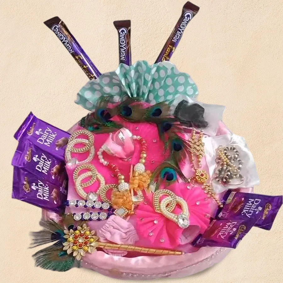 Elegant Ladoo Gopal dress set with jewelry and a chocolate gift basket