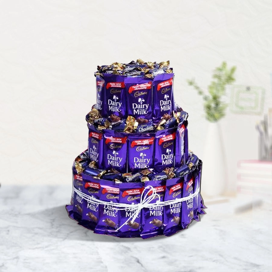 Triple layer arrangement of Cadbury chocolates including Dairy Milk bars and Chocolairs Gold, beautifully presented for Valentine's Day.