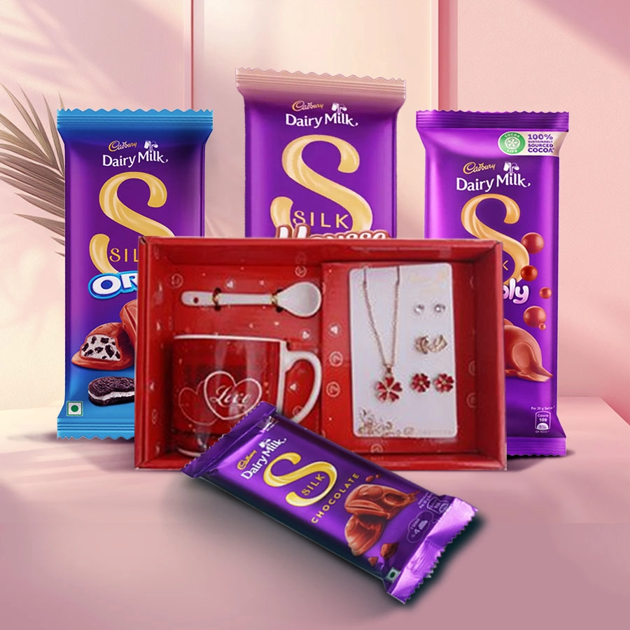 Love mug, jewelry set, and assortment of Cadbury chocolates in a romantic display