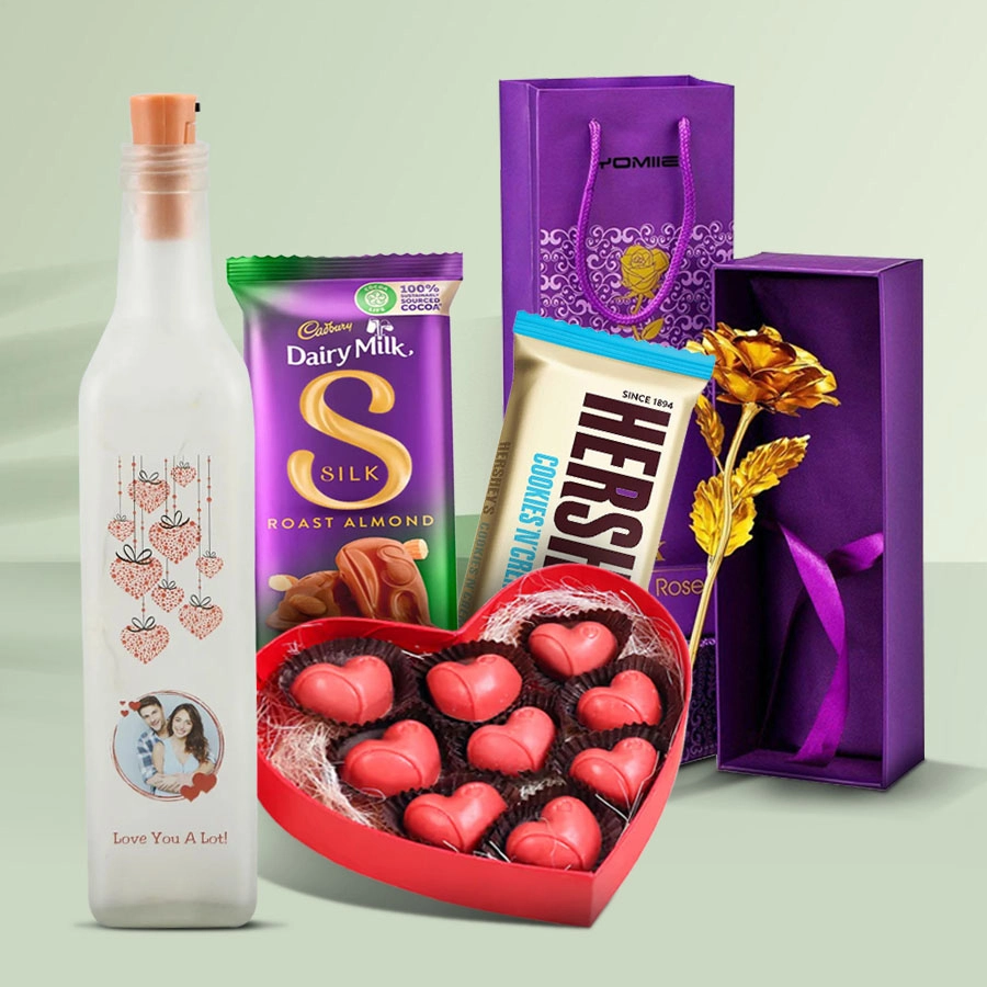 Playful Romance Valentine Gift Combo featuring a personalized Love Bottle LED Lamp, a 6-inch Golden Rose, a heart-shaped box of 11 handmade chocolates, and treats from Hershey's and Cadbury Dairy Milk