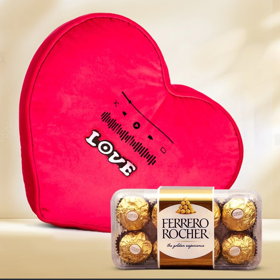 Musical heart cushion alongside a box of Ferrero Rocher chocolates for Valentine's Day gift