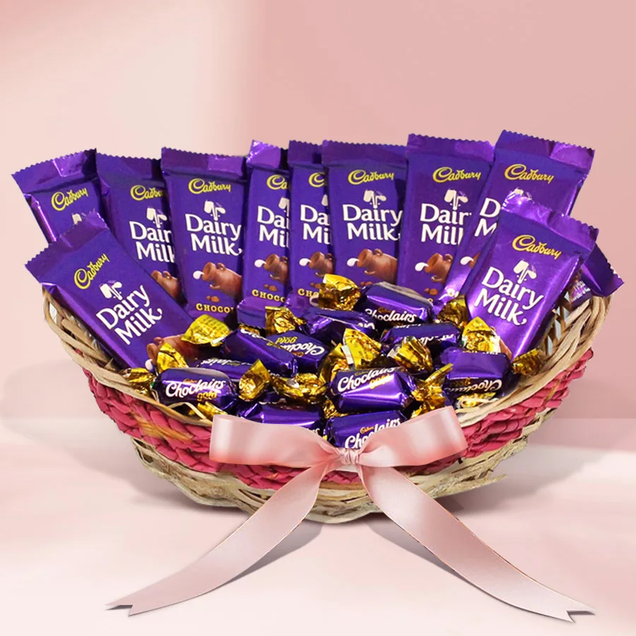 A beautifully arranged cane basket filled with 12 Cadbury Dairy Milk bars and 30 Cadbury Chocolairs Gold candies, designed for a romantic Valentine's gift.