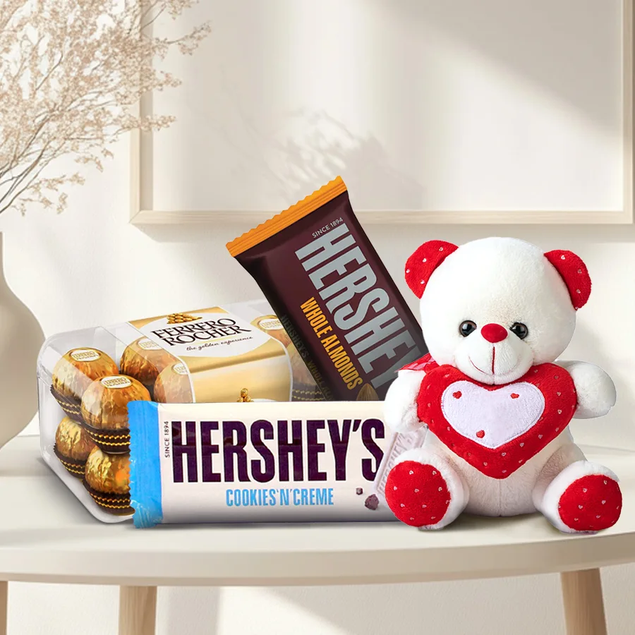 Superb combo of Ferrero Rocher chocolates, Hershey's Whole Almonds and Cookies 'n' Creme bars, and a cuddly red and white teddy bear holding a heart, perfect for Valentine's Day gift.