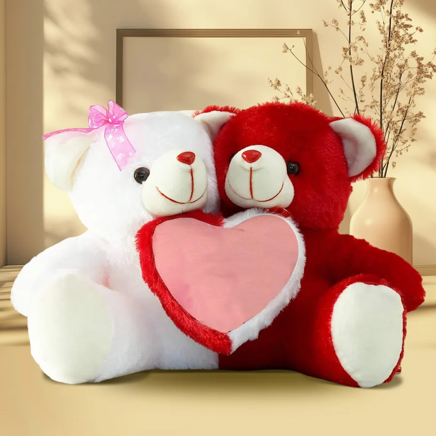 Two red and white plush teddy bears holding a vibrant red heart, symbolizing love and affection for Teddy Day.