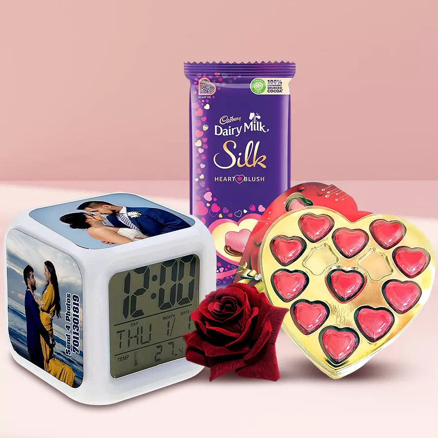 Personalized photo clock surrounded by heart-shaped chocolates and red roses for Valentine's Day gift.