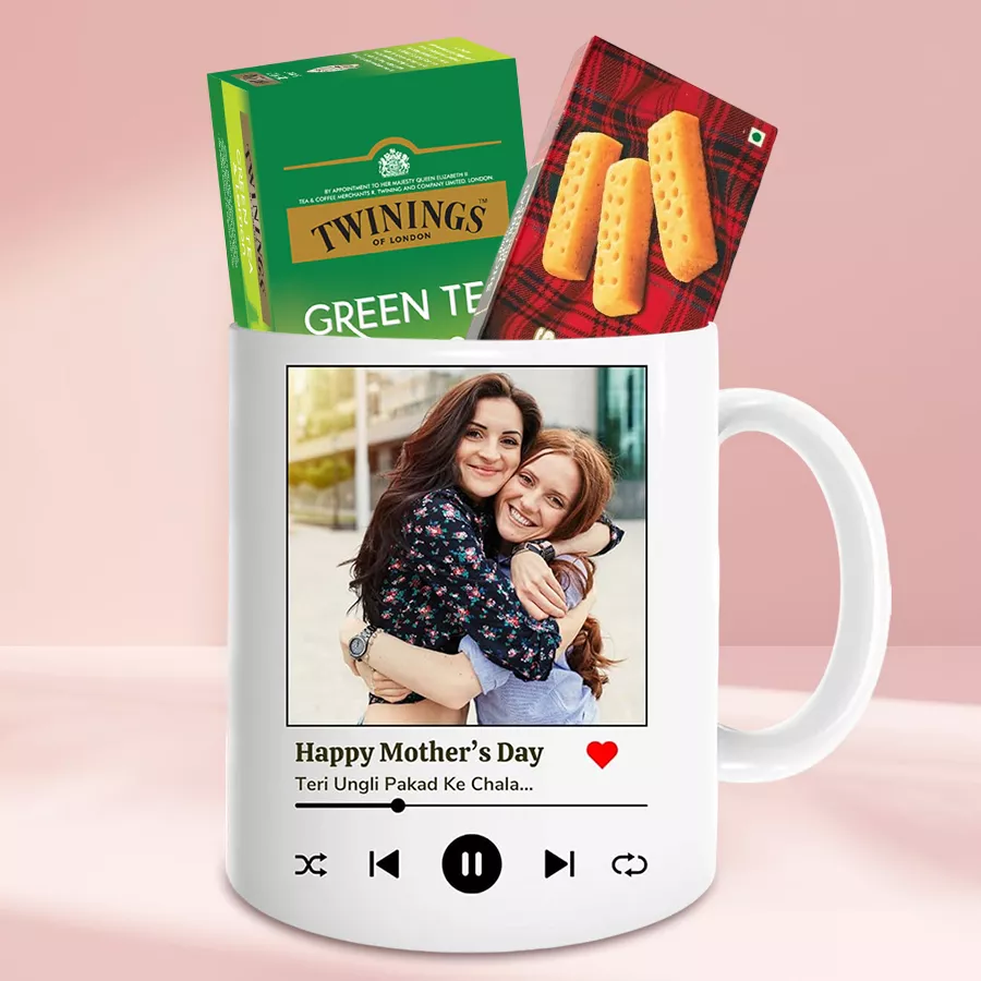 Personalized photo coffee mug with Twinings Green Tea and Walker Cookies on a wooden table