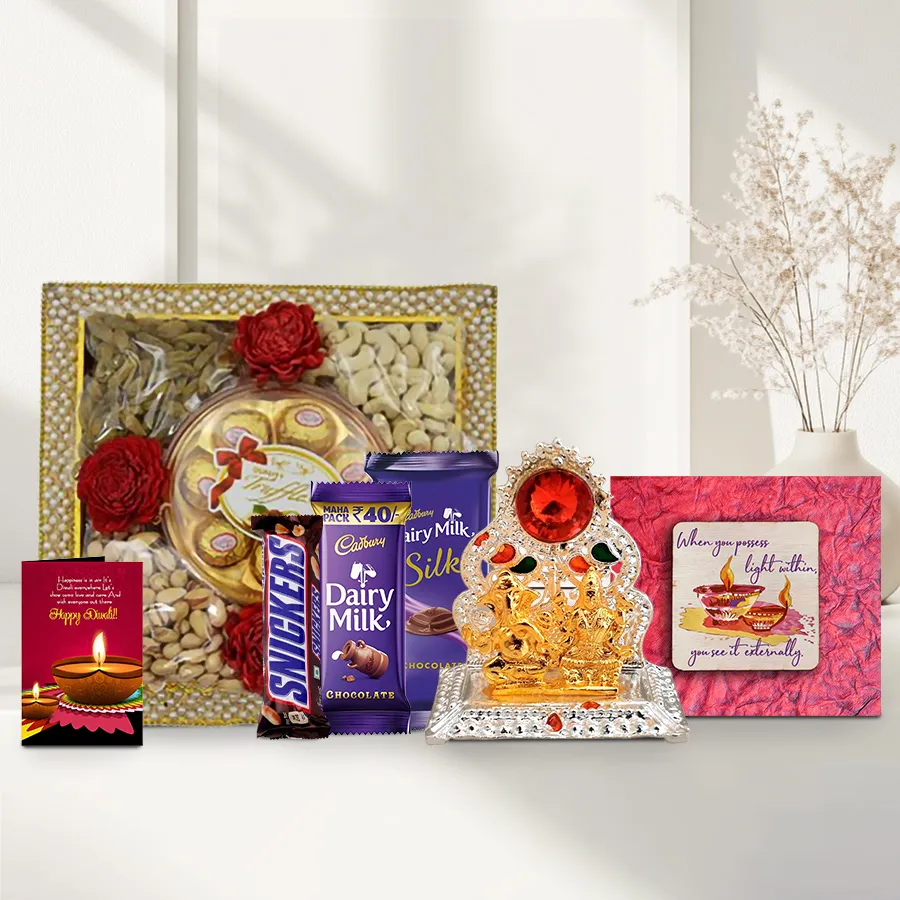 A beautifully arranged Diwali gift hamper featuring a pearl-adorned tray with cashews, raisins, almonds, pistachios, premium chocolates, a Ganesh Lakshmi Mandap, a handmade fridge magnet, and a Diwali wishing card.