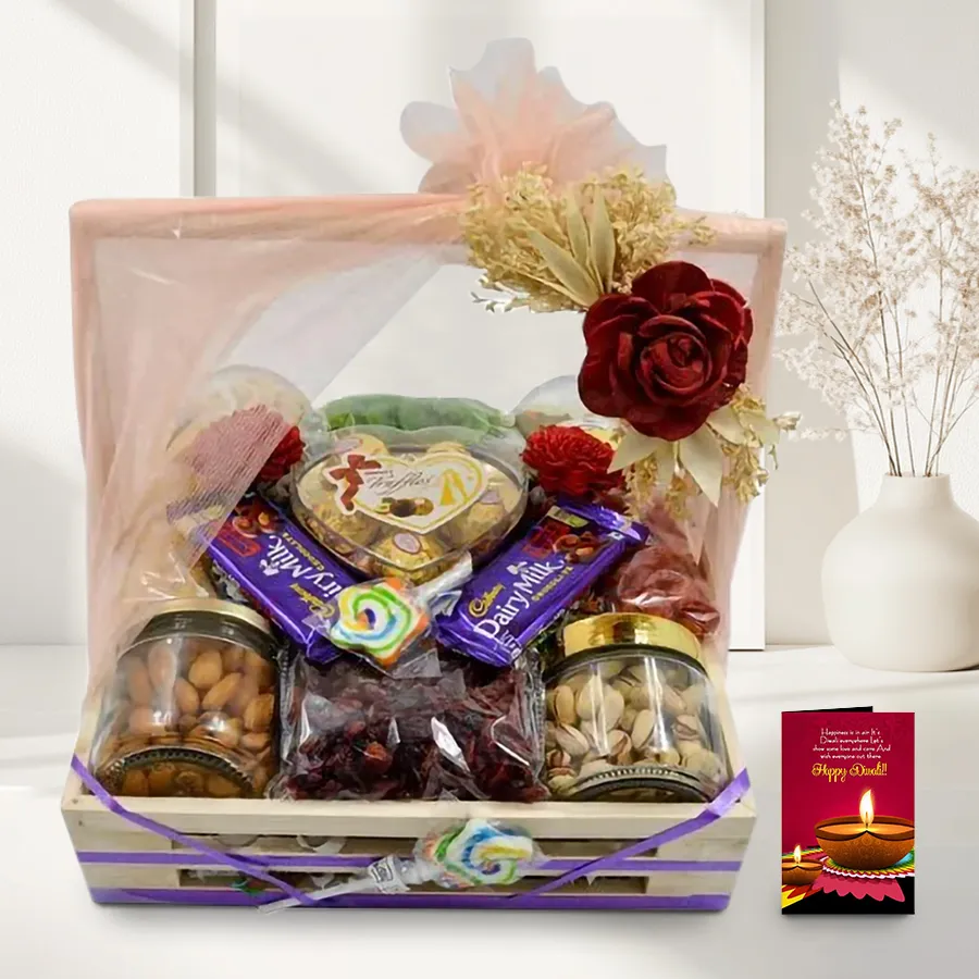 A beautifully arranged Diwali hamper featuring premium nuts like cashews, almonds, and pistachios, assorted dried fruits, Cadbury and Sapphire chocolates, candies in glass jars, all presented in a reusable wooden tray with a handle and a Diwali greeting card.