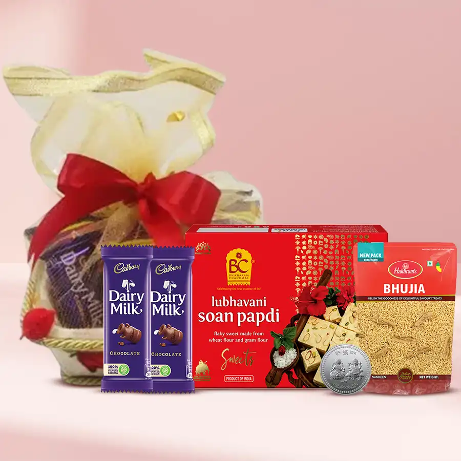 Sweets n Munchies Hamper with chocolate delights, including Soan Papdi, crispy Bhujiya, Cadbury Dairy Milk bars, and a Silver Plated Ganesh Laxmi Coin, beautifully arranged in a decorative gift basket.