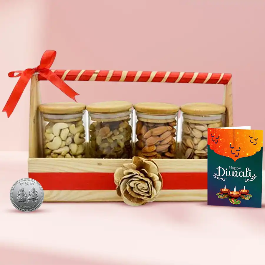 Healthy Bites Diwali Gifts Tray featuring a wooden basket with four glass jars filled with cashews, raisins, almonds, and pistachios, alongside a silver-plated Ganesh Lakshmi coin and a Diwali wishing card.