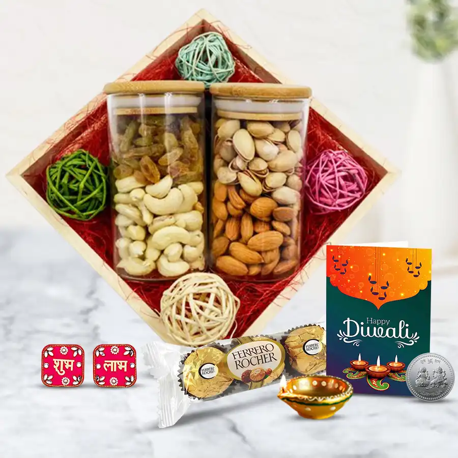 Cheerful Vibes Dry Fruit and Diya Combo featuring a wooden tray with glass jars of dry fruits, Ferrero Rocher chocolates, a designer diya, Shubh Labh wall sticker, silver-plated coin, and a Diwali greetings card