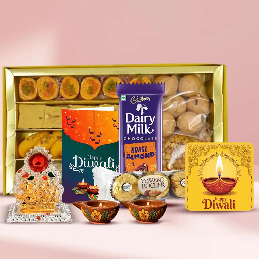 Diwali gift hamper featuring assorted Indian sweets, crunchy snacks, Ferrero Rocher and Cadbury chocolates, fancy diyas, a handmade fridge magnet, Ganesh Lakshmi Mandap, and a heartfelt Diwali card