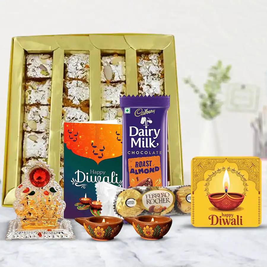 Taste of Elegance Diwali Gift Box featuring sweets, chocolates, Diyas, Ganesh-Laxmi mandap, and a handmade fridge magnet