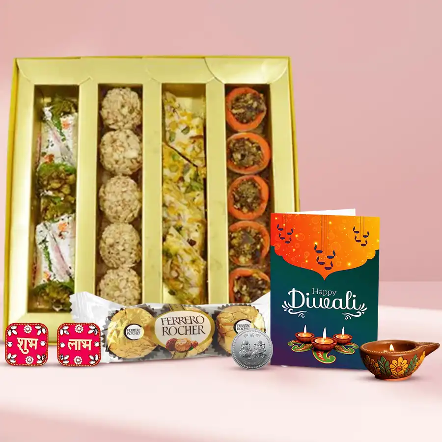 Affable Indulgence Festive Gift Hamper featuring premium Kaju sweets, Ferrero Rocher chocolates, a fancy diya, Shubh Labh wall stickers, a silver-plated Ganesh Laxmi coin, and a Diwali card