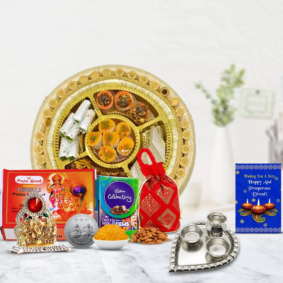 Showstopper Diwali Gift Hamper featuring mixed sweets platter, Cadbury Dairy Milk treats, crunchy almonds, Ganesh Lakshmi Mandap, silver paan-shaped pooja thali, pooja samagri, and a Diwali card