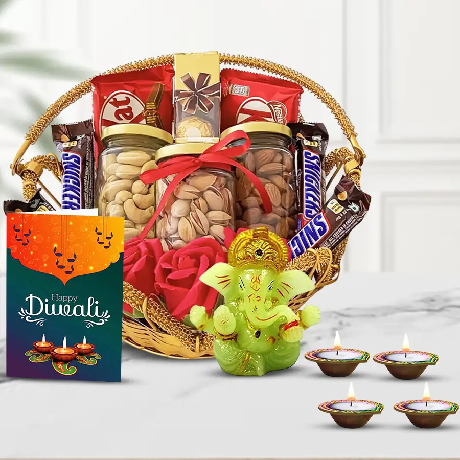 All in One Diwali Gift Hamper featuring chocolates, premium nuts in glass jars, Ganesh idol, reusable wax diyas, and a decorative basket with a Diwali wishing card.