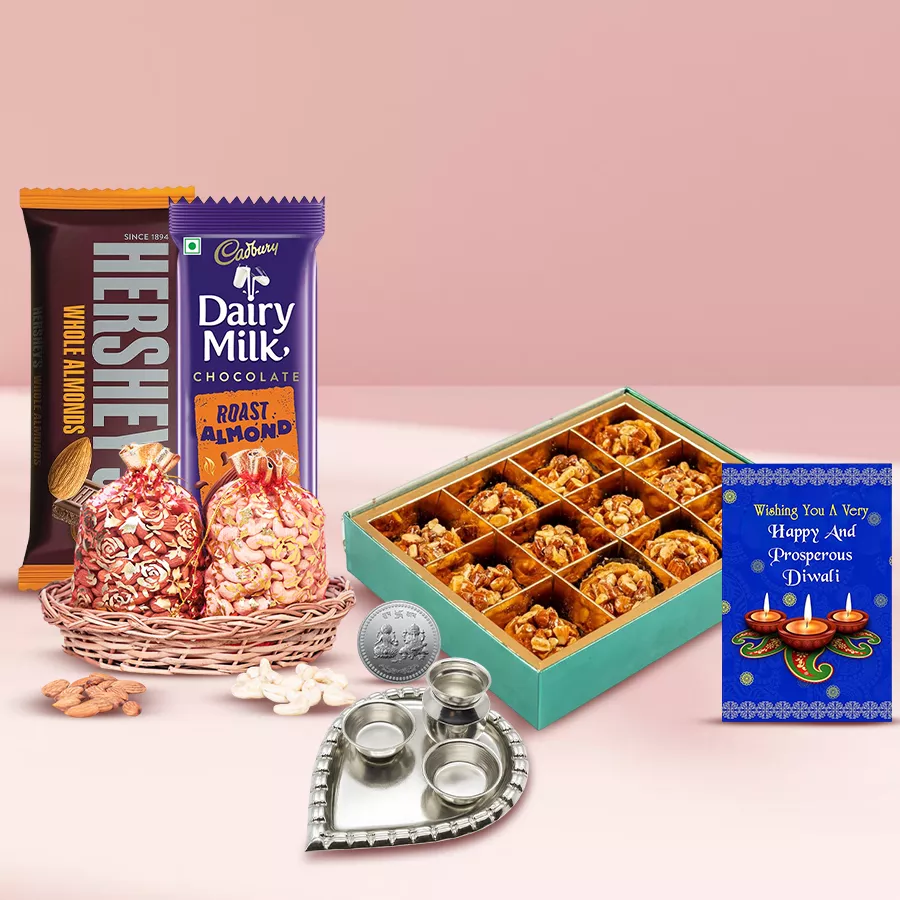 Ambrosial Almond Tart Baklava and Chocolates hamper with almond tart baklava, Cadbury and Hershey’s almond chocolate bars, almond and cashew potlis, silver-plated Ganesh-Laxmi coins, paan-shaped pooja thali, and a Diwali card