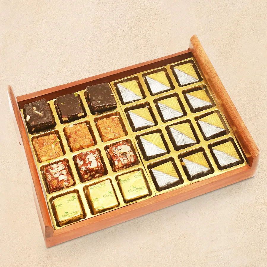 Handmade chocolate and golden diya duo in a rustic wooden tray for Deepavali celebrations