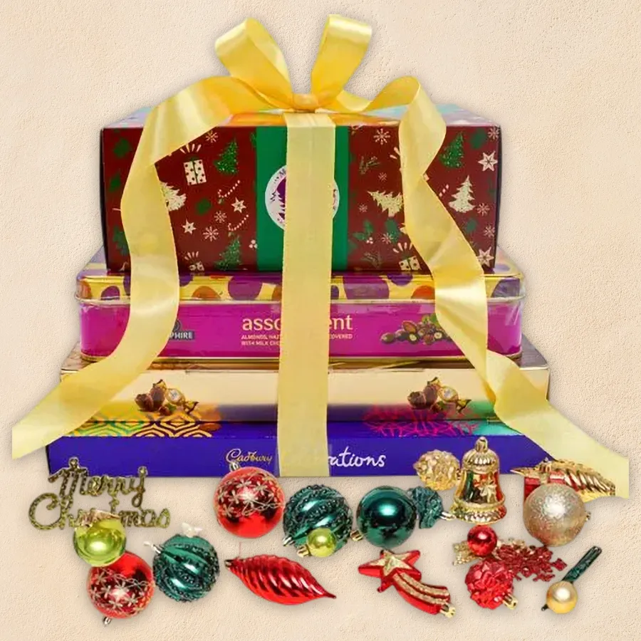 Enticing Chocolate Tower with Christmas decorative combo featuring fruit cake, Ferrero Rocher, Cadbury celebration box, and fruit n' nut chocolate tin
