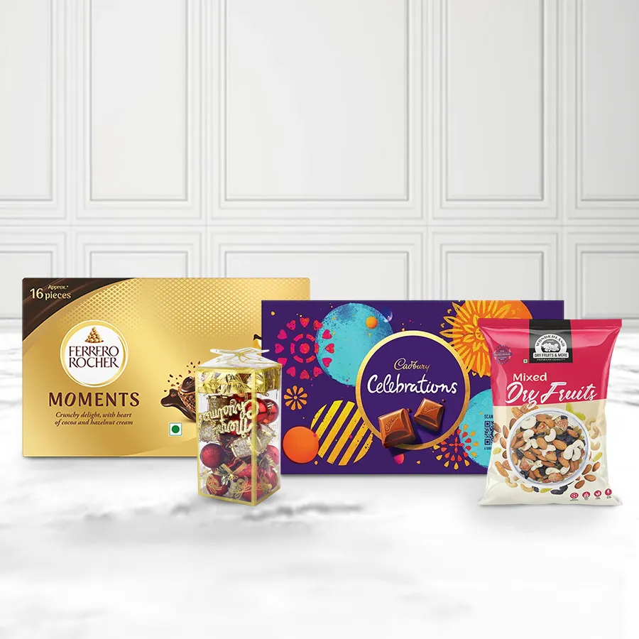 Christmas Special Chocolate & Nuts Tower Combo featuring Ferrero Rocher chocolates, premium mixed dried nuts, Cadbury Celebration chocolates, and a box of Christmas decor.