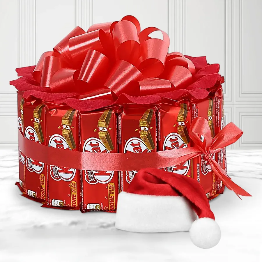 Bustling Joy Kitkat Arrangement featuring 15 Nestle Kit Kat bars and a cute Santa hat, perfect for Christmas celebrations.