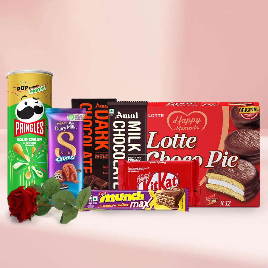 Magnificent Assorted Goodies Gift Box featuring Pringle Chips, Cadbury Silk Oreo, Amul Dark & Milk Chocolate Bars, Munch Wafers, KitKat fingers, Lotte Chocopie, and a bouquet of red roses.