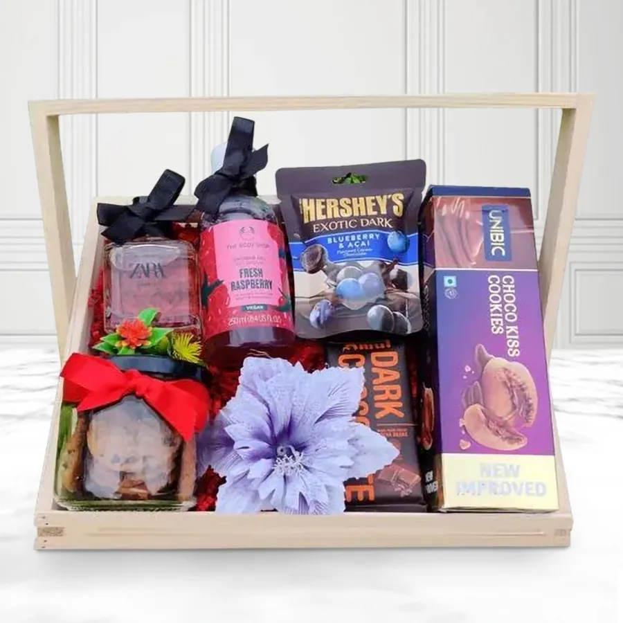 Sensational Gift Basket for Women featuring Body Shop Shower Gel, Zara Perfume, crunchy cookies, Amul Dark Chocolate, Hershey’s Blueberry & Acai bites, UNIBIC Chocokiss Cookies, all arranged in a reusable wooden basket.