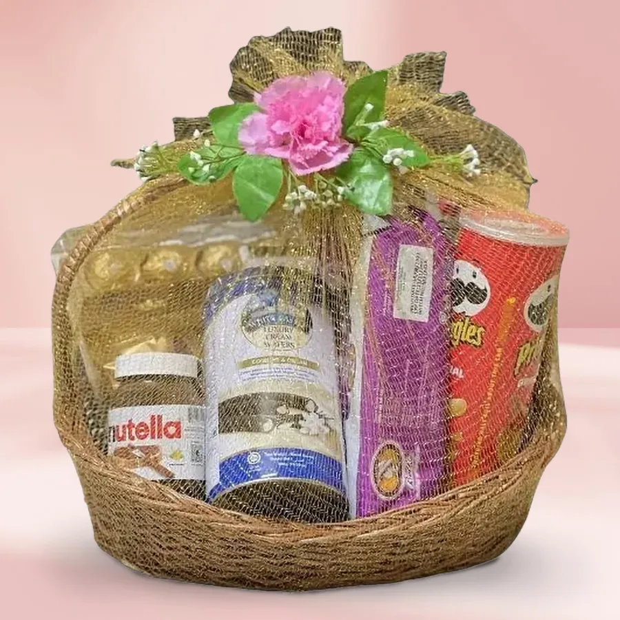 Exciting Sweet N Savory Gift Basket filled with Ferrero Rocher chocolates, Nutella Choco Spread, White Castle Rolled Wafers, Pringle Chips, and European Cookies arranged in a stylish cane basket.