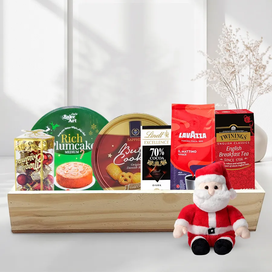 Gift Tray of Christmas Delights featuring a fruit cake, Danish cookies, English Breakfast tea, Lavazza coffee, dark chocolate bar, and festive decorations on a wooden tray.