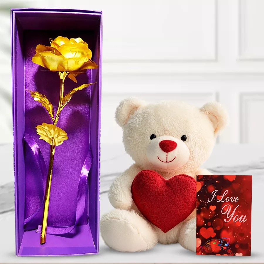 Cream and red teddy bear with a heart, artificial golden rose, and "I Love You" card arranged together as a gift set for Valentine's Day.