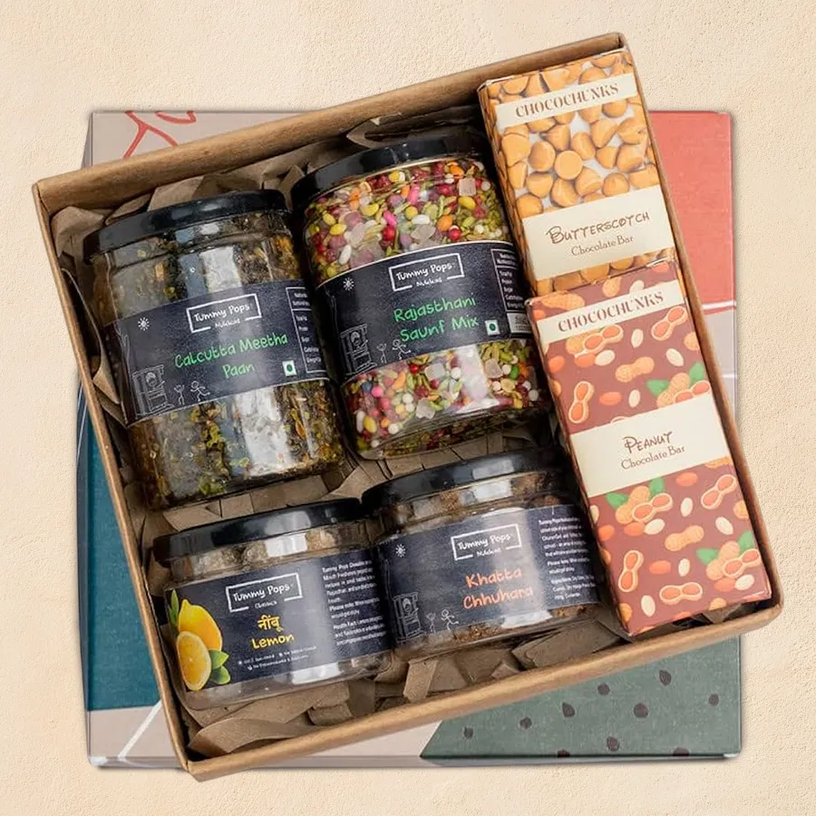 Gift pack featuring four flavors of mukhwas and two chocolate bars, showcasing traditional snacks and sweets.