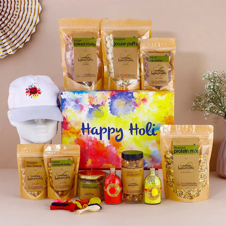 Ravishing gift hamper with assorted sweets and a jar of organic gulal for Holi celebrations