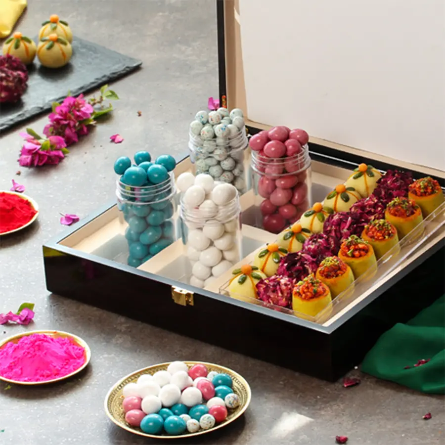 Flavorful assorted ladoos and dragees gift box for Holi celebration with a cheerful greetings card