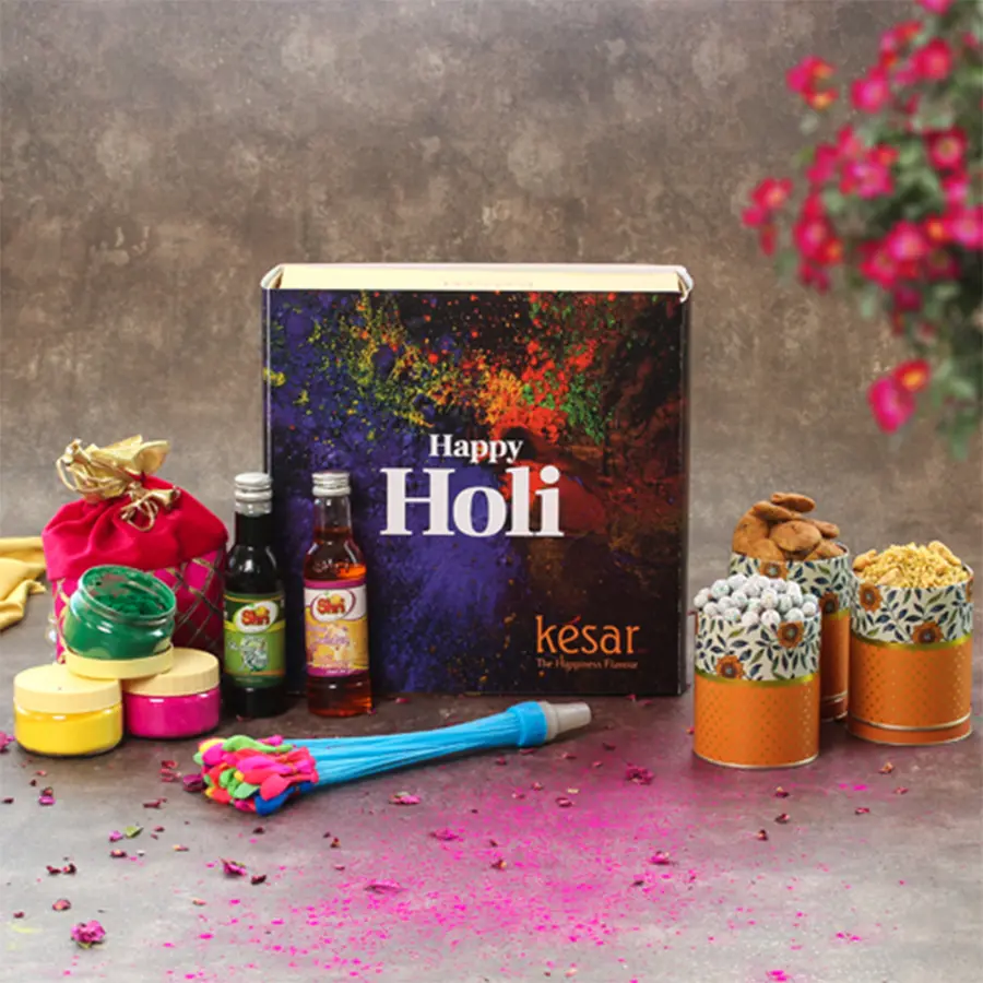 Premium Holi Delight Box featuring water balloons, herbal colors, treats like Methi Suwali, Shahi Mixture, Rainbow Butterscotch Dragees, Sharbat, and a Holi greeting card, all in a beautifully packed corrugated box.