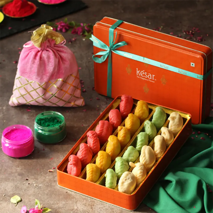 Marvelous Assorted Chandrakala with Herbal Gulal Potli presented in a charming gift box, featuring vibrant colors and a Holi greetings card.