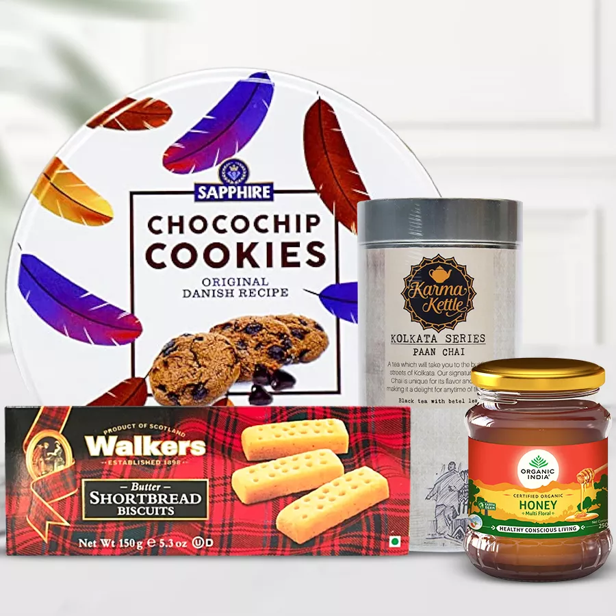 Flavored Paan Cha and Snacks Delight Hamper featuring Karma Kettle Paan Cha, Sapphire Chocochip Cookies, Walkers Short Bread Biscuits, and Indian Organic Honey