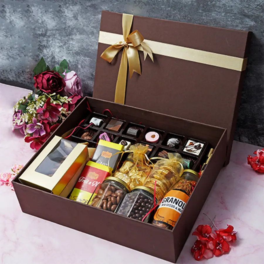 Mother's Day gift box filled with assorted chocolates, cookies, fruity and Oreo bars, butterscotch, raisins, almond rocks, Florentines, granola bottle, and assorted logs.