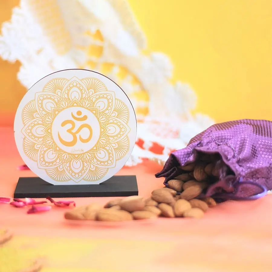 Om Idol N Almond Potli Gift Set featuring a handcrafted Om idol and a potli filled with 150g of premium almonds, beautifully packaged for Diwali celebration.
