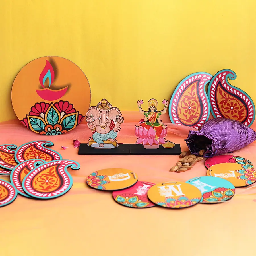 Hamper containing Ganesh and Laxmi idols, festive bunting, a premium almond potli, a diya, and a rangoli set for Diwali celebrations