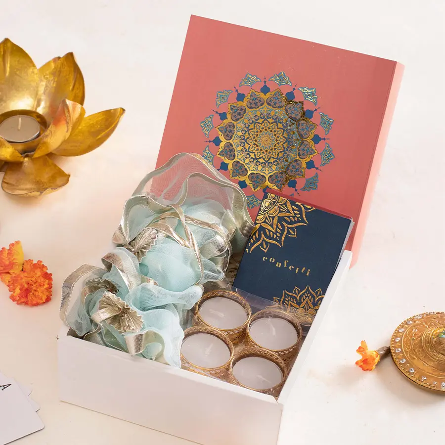 Diwali Glow: Joyful Presents gift box with playing cards, blue toran, T-light holders, and violet Mandal Box