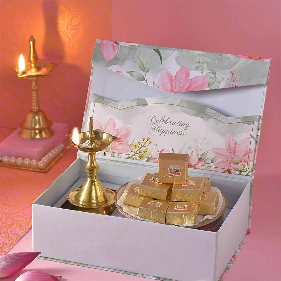 Festive Celebrations N Delicious Bites Box featuring a 5-inch Brass Udupi Deep and 10 handcrafted Assorted Mewa Bites, designed for Diwali celebrations.