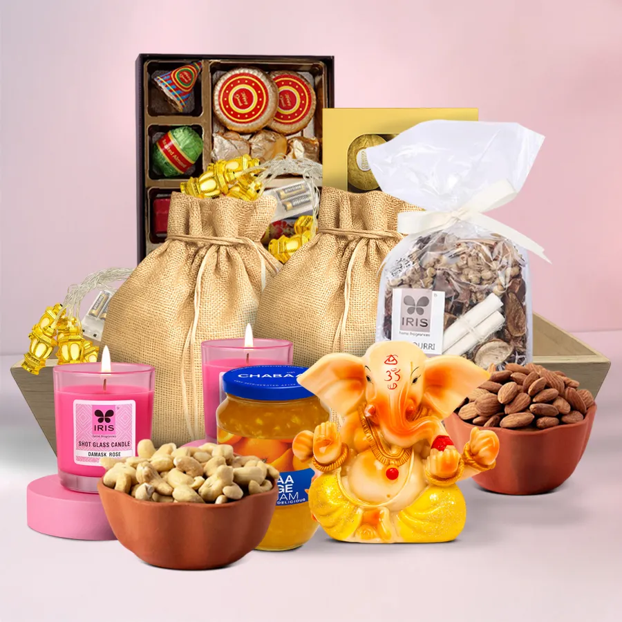 An exquisite festive Diwali hamper featuring premium cashews, almonds, Ferrero Rocher chocolates, imported orange jam, Iris scented candles, potpourri, a traditional Vignesh Ganesh figurine, ethnic LED lanterns, all presented in a designer wooden tray.