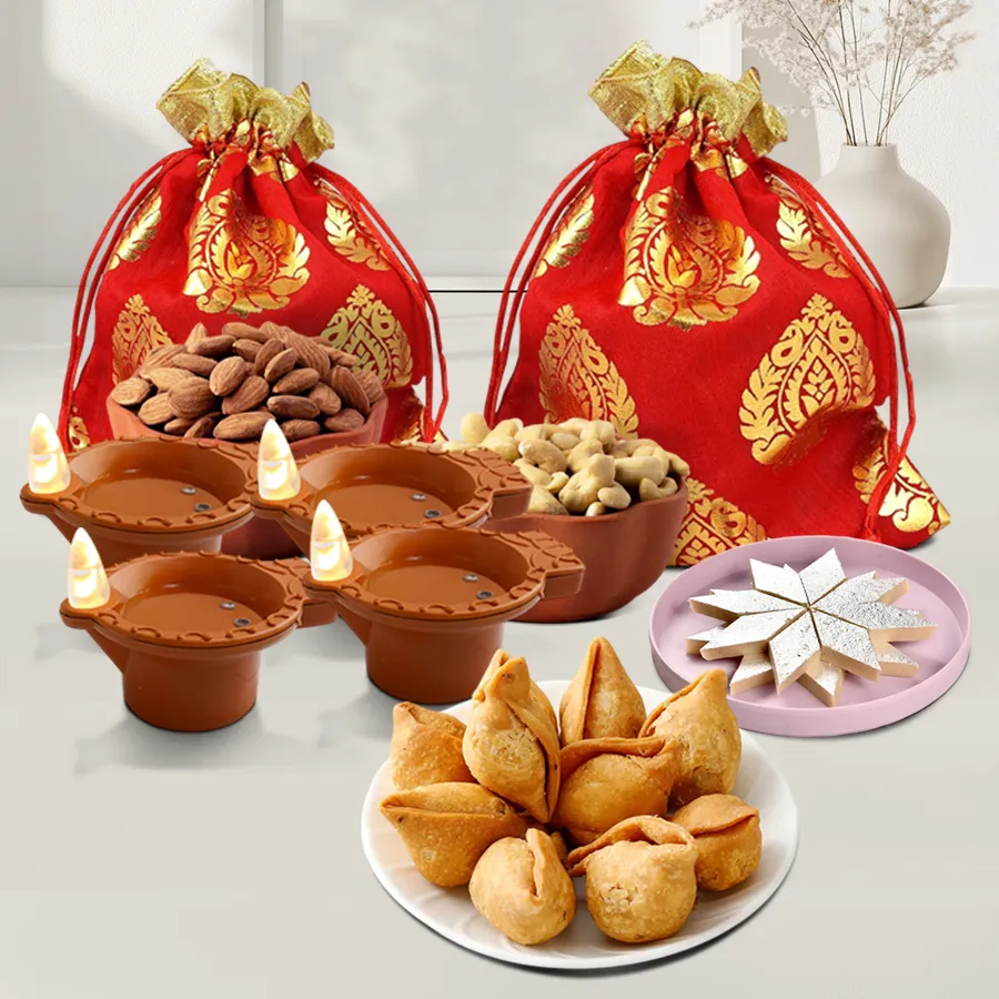 Diwali gift box featuring premium cashews and almonds in potlis, kaju katli, mini samosas, and LED water sensor diyas