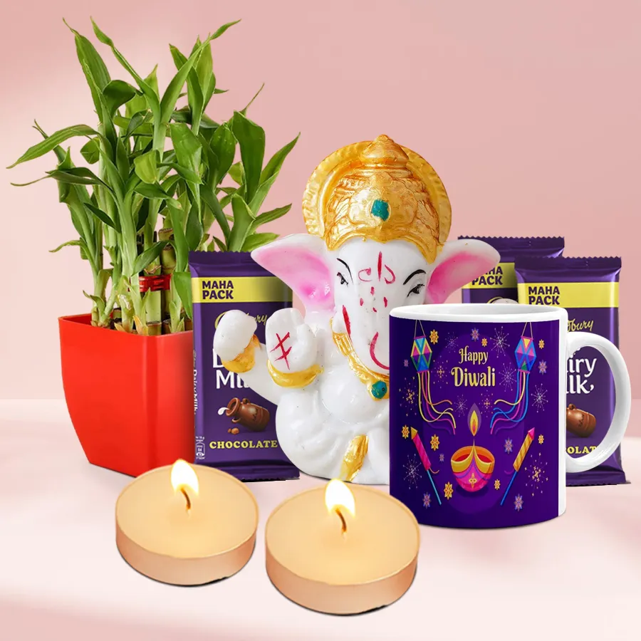 Illuminating Moments Diwali Gift Set featuring a Mukut Ganesh idol, lucky bamboo plant, ceramic mug, Cadbury Dairy Milk chocolates, and scented T-light candles arranged beautifully for a festive celebration.