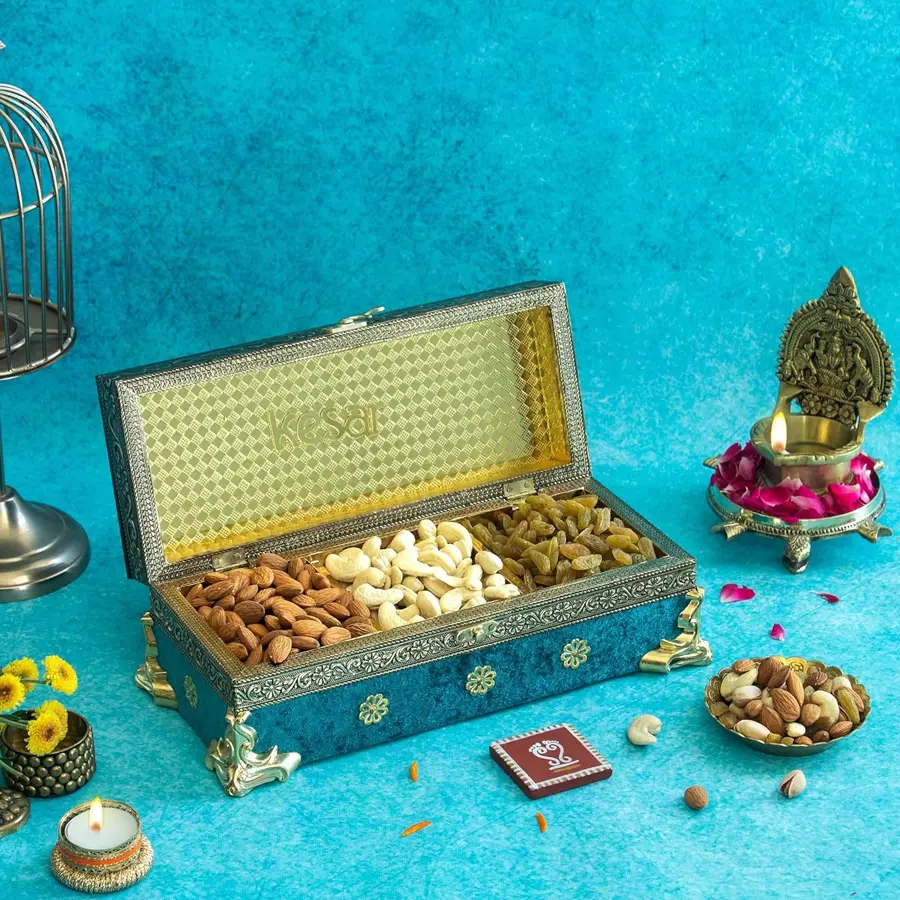 Delectable nut assortment in a turquoise metal box featuring buttery cashews, crunchy almonds, and sweet raisins for Diwali celebrations