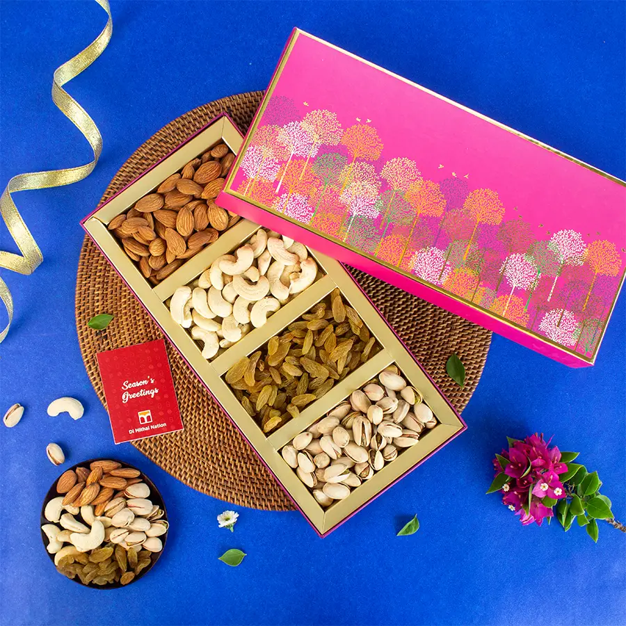 Delightful Nut Medley Gift Box filled with cashews, almonds, pistachios, and raisins in a pink tree box with a greeting card.