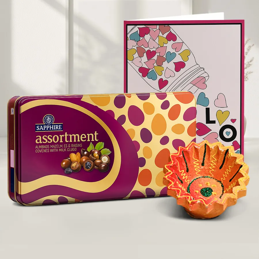Diwali chocolates and card hamper featuring assorted chocolates, a decorative Diya, and a message card