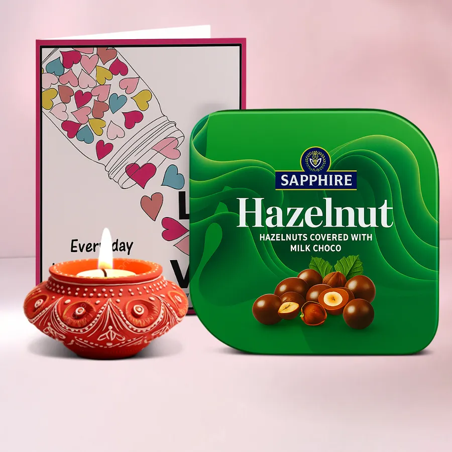 Sweet Surprises Diya with Sapphire Chocolates hamper featuring a handcrafted diya, a box of hazelnut chocolates, and a message card, all presented in a festive setting.