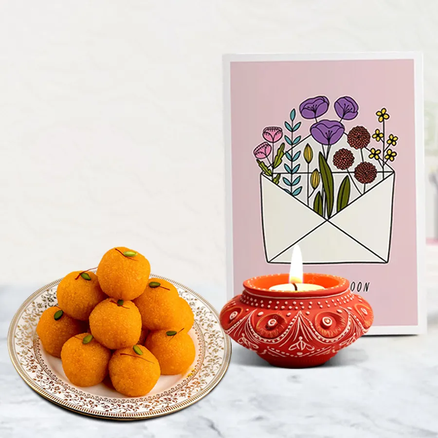 Festive Diwali hamper featuring a traditional Diya, 500g Motichoor Laddu, and a personalized message card