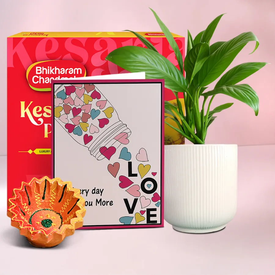 Diwali Serenity And Treats hamper featuring a beautifully crafted Diya, a 500g box of Kesaria Peda, and a Peace Lily Plant, all presented in an elegant arrangement.